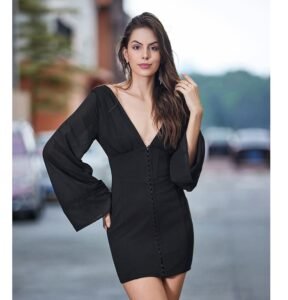 Woman styling black elegant long-sleeved mini dress outdoors