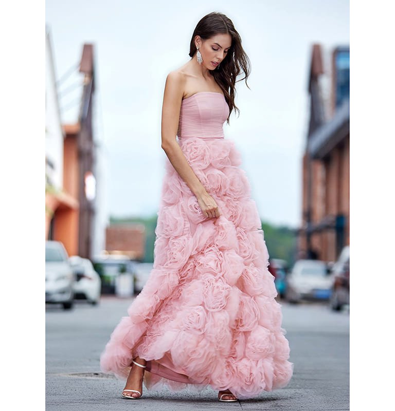 Model wearing stunning pink evening dress outdoors