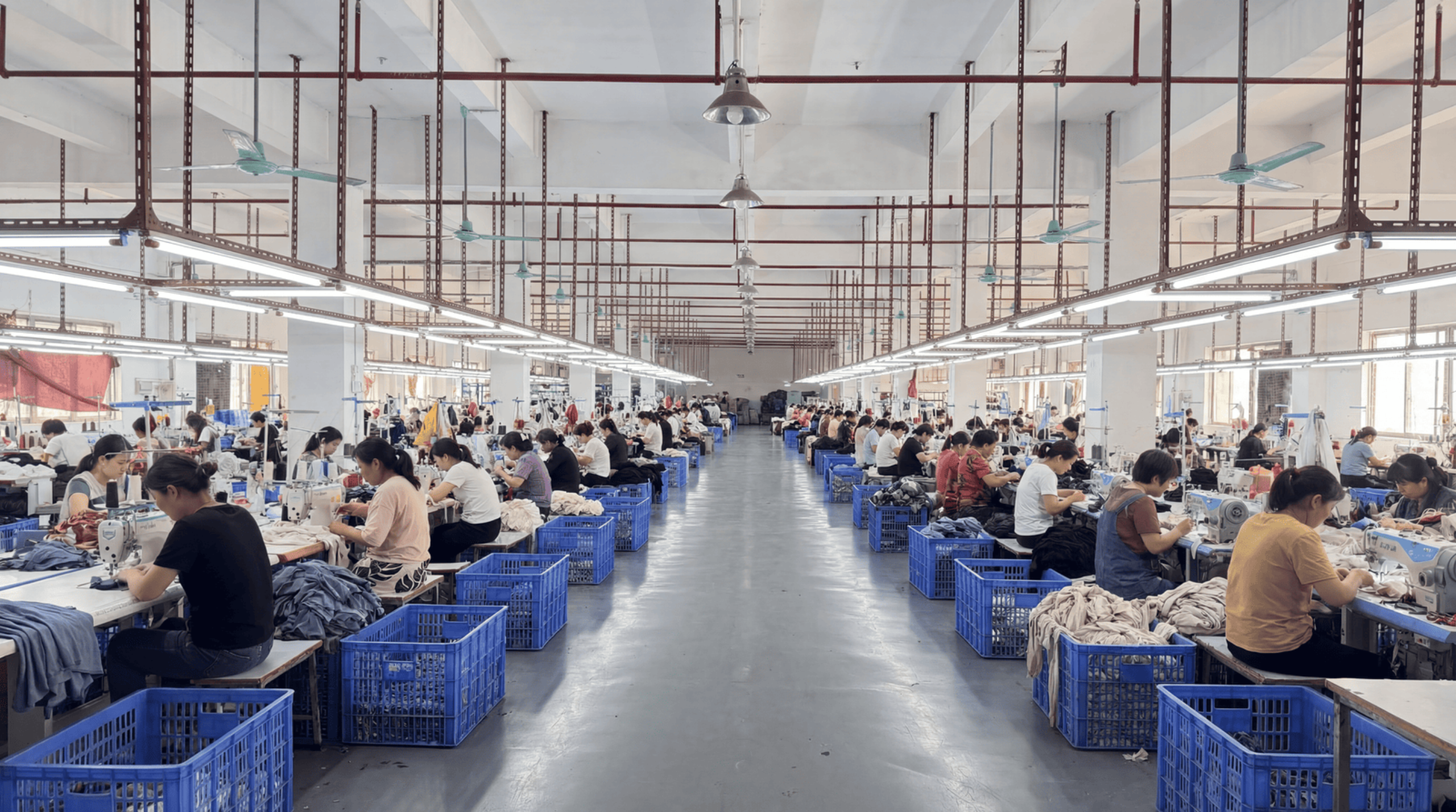 Orangesea Clothing factory workshop production line showing modern manufacturing equipment and quality control processes