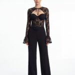 Front static shot of lace corset top matched with wide-leg black trousers