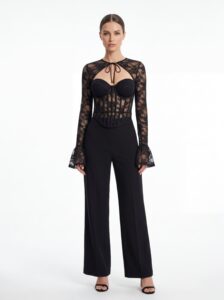 Front static shot of lace corset top matched with wide-leg black trousers
