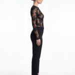 Side profile demonstrating torso contour from black lace corset top