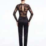 Straight back view presenting structured black lace corset long sleeve top