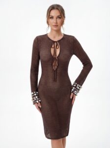 Front view of brown knit midi dress, model resting one hand on hip