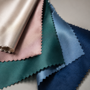 Infographic comparing satin weaves: polyester vs silk, with weight and drape characteristics.